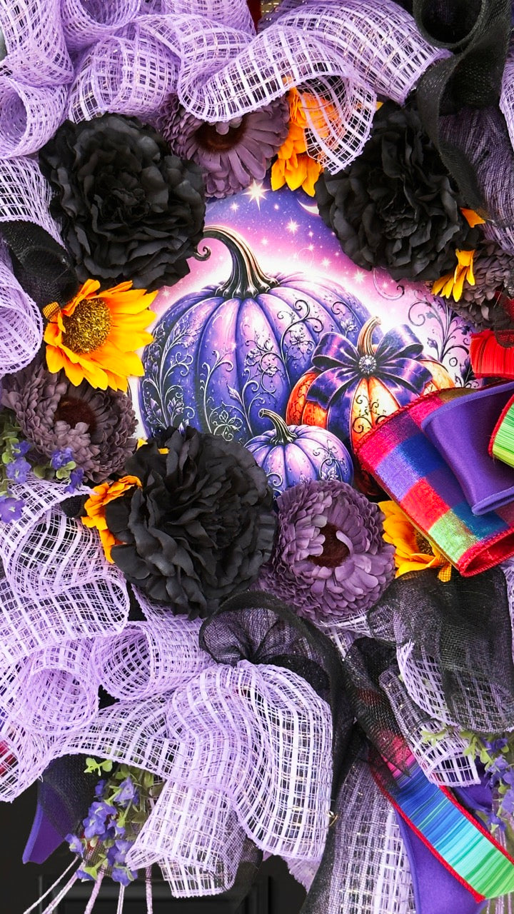 Velvet Eclipse luxury handmade Halloween wreath featuring lavender deco mesh, black florals, colorful designer ribbon bow, sunflowers, and a whimsical purple pumpkin centerpiece displayed on a black front door.