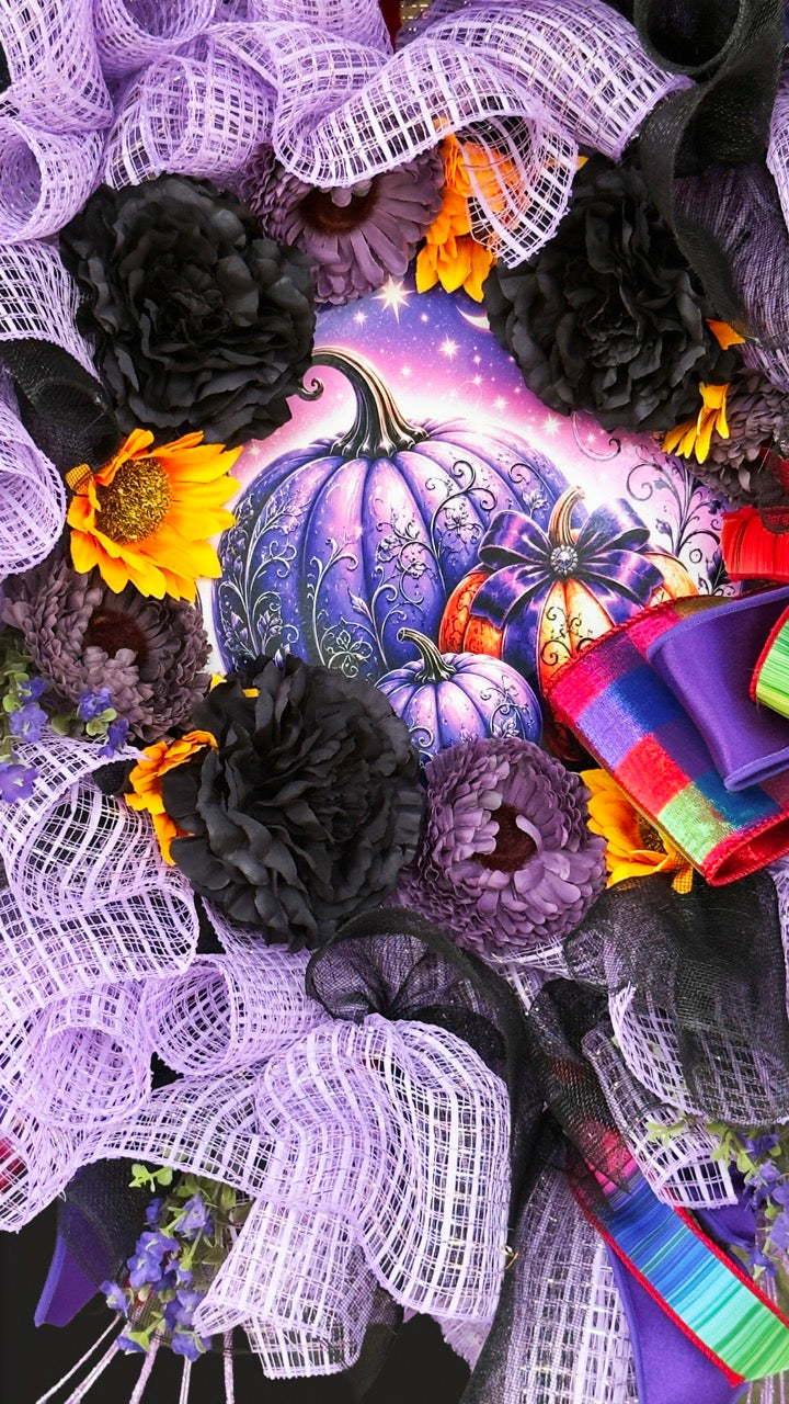 Velvet Eclipse luxury handmade Halloween wreath featuring lavender deco mesh, black florals, colorful designer ribbon bow, sunflowers, and a whimsical purple pumpkin centerpiece displayed on a black front door.