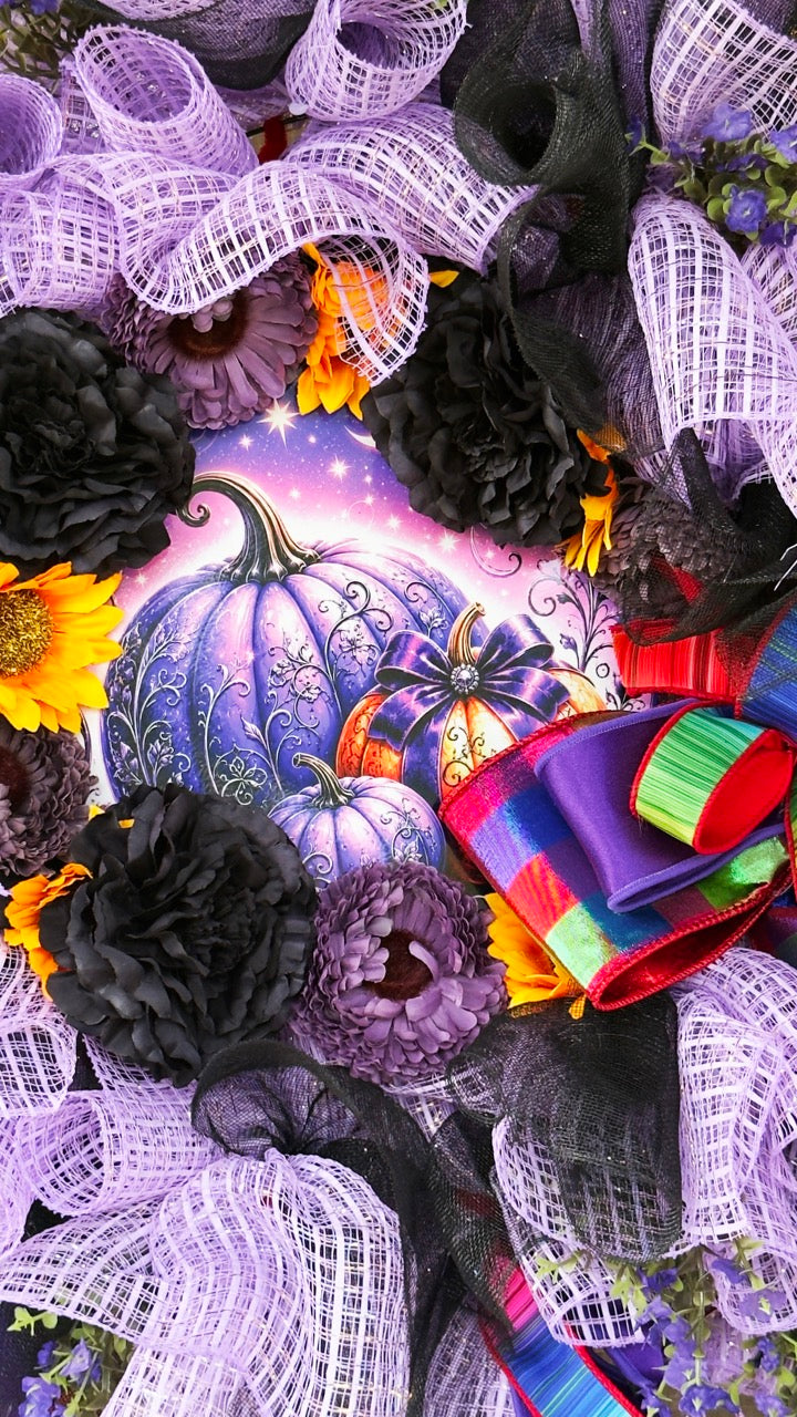 Velvet Eclipse luxury handmade Halloween wreath featuring lavender deco mesh, black florals, colorful designer ribbon bow, sunflowers, and a whimsical purple pumpkin centerpiece displayed on a black front door.