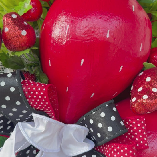 Luxury handmade strawberry door swag with oversized red strawberries, glitter strawberry ornaments, bright green foliage, white flowers, and a designer black, red, white, and green ribbon bow, perfect for summer front door décor and farmhouse-style decorating. 🍓✨