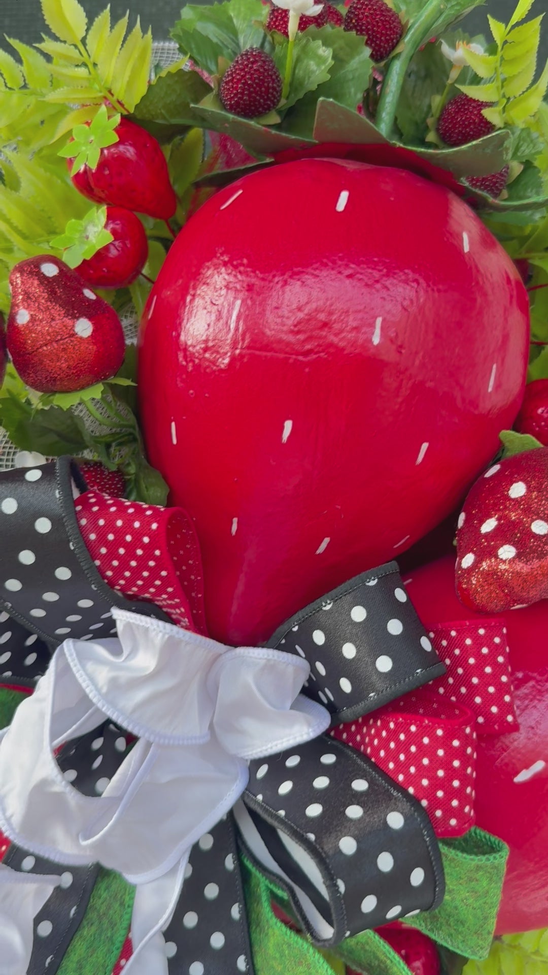 Luxury handmade strawberry door swag with oversized red strawberries, glitter strawberry ornaments, bright green foliage, white flowers, and a designer black, red, white, and green ribbon bow, perfect for summer front door décor and farmhouse-style decorating. 🍓✨
