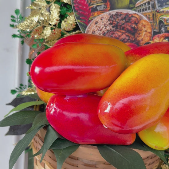 Luxury handmade Jamaica-inspired door wreath featuring green, black, and gold designer ribbons, tropical fruit basket, glittered foliage, and colorful island-themed artwork celebrating Jamaican culture and Caribbean décor.