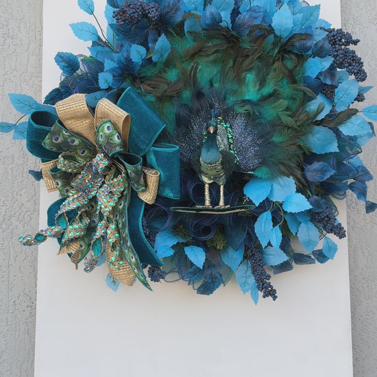 Full view of handmade peacock wreath with measuring tape showing the finished dimensions.