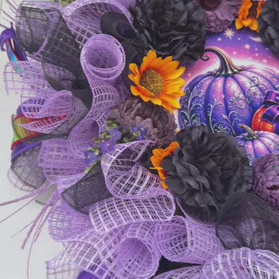 Velvet Eclipse luxury handmade Halloween wreath featuring lavender deco mesh, black florals, colorful designer ribbon bow, sunflowers, and a whimsical purple pumpkin centerpiece displayed on a black front door.